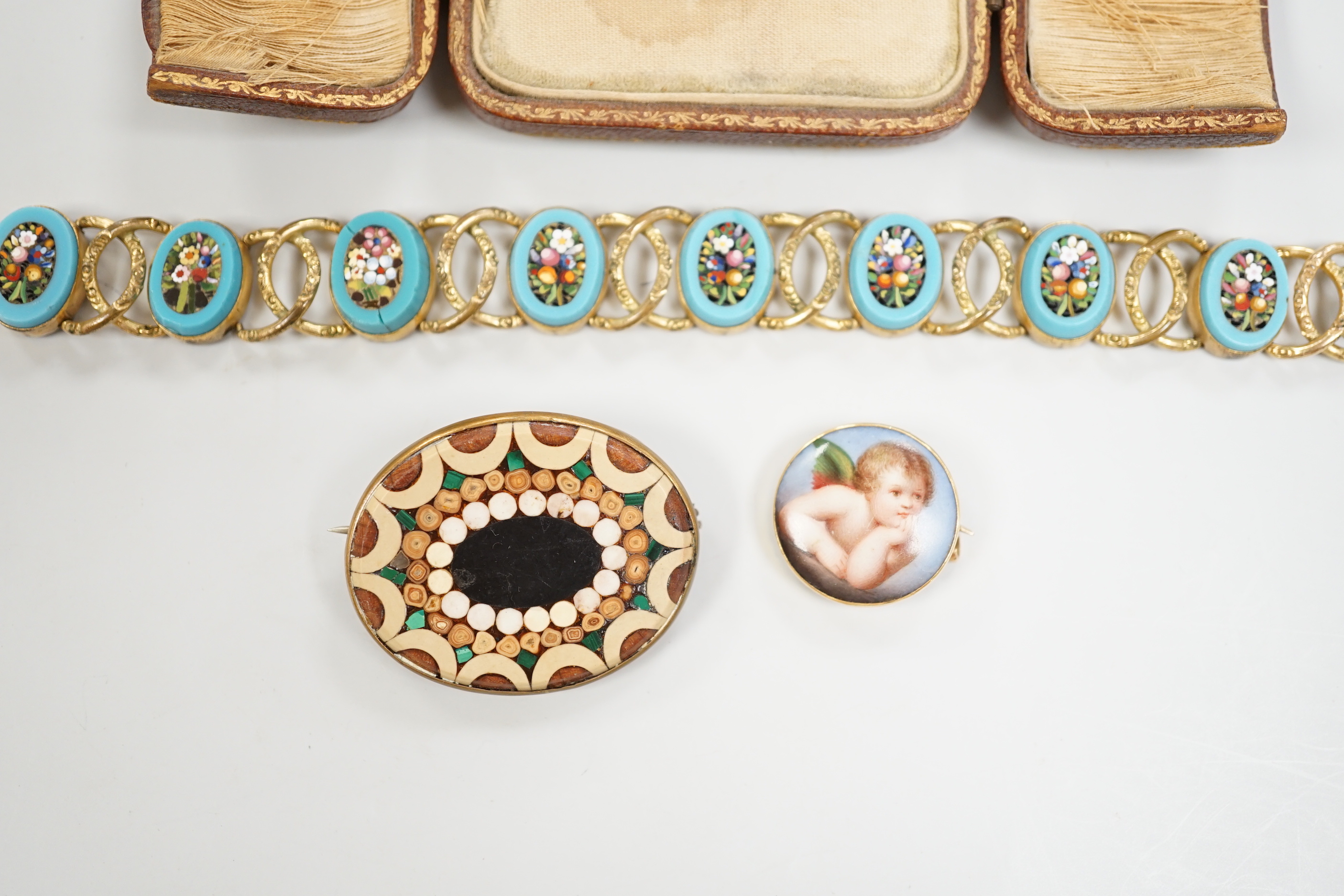 A Tassie style cased cameo, a micro-mosaic bracelet, a pietra dura brooch and a porcelain brooch.